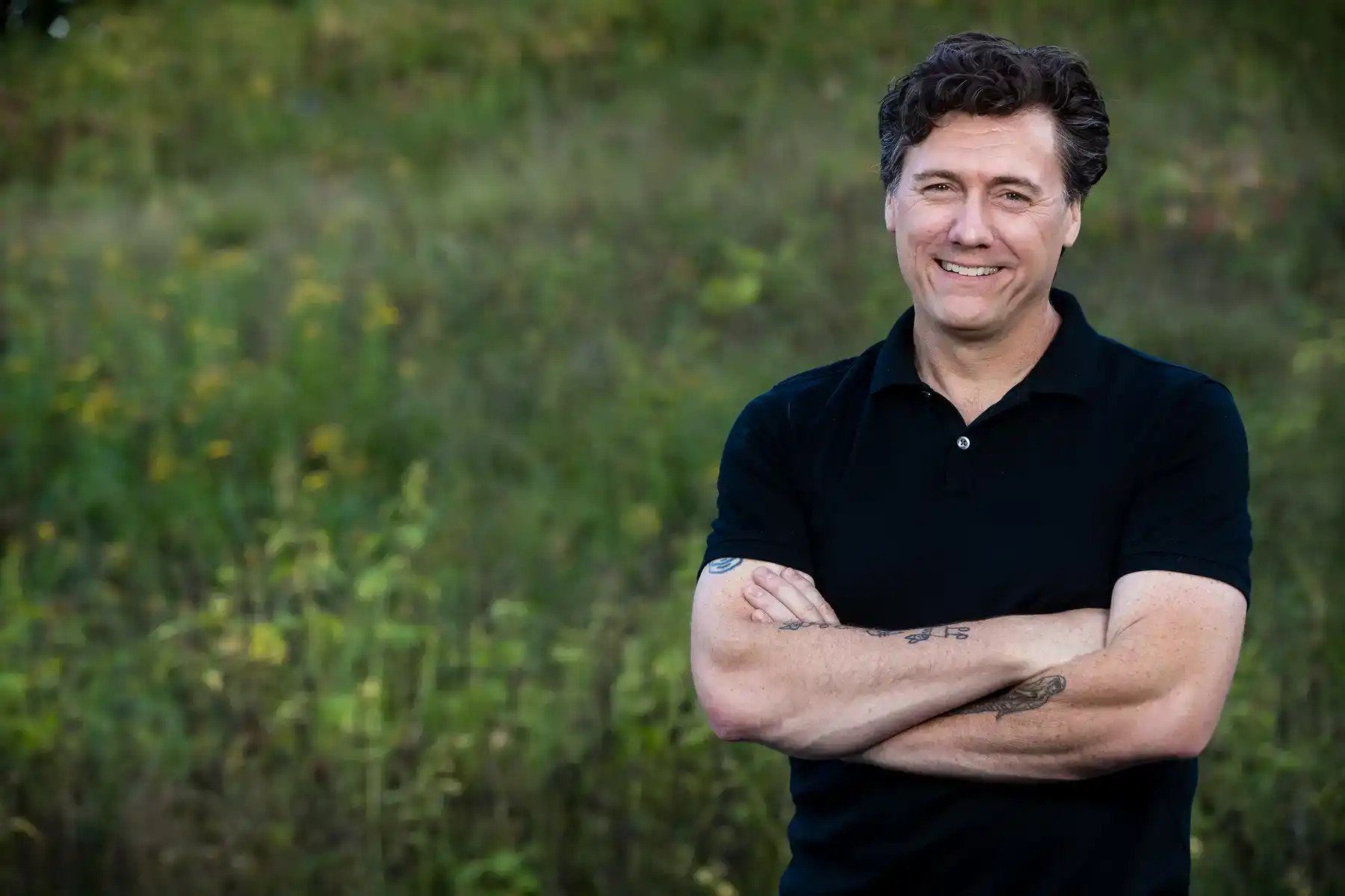 Aric Putnam standing outdoors in a field