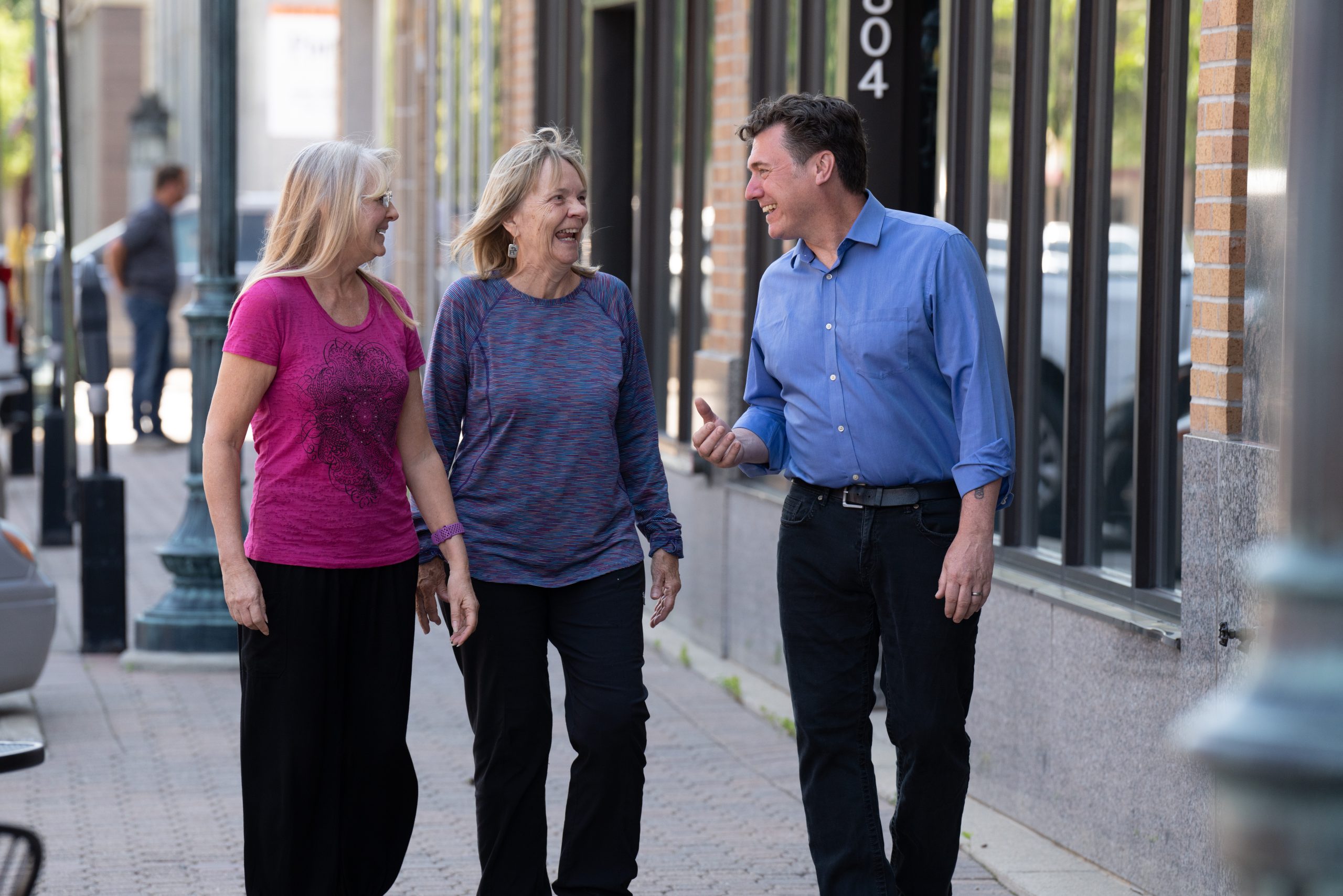 Aric Putnam talking with two constituents in downtown St. Cloud