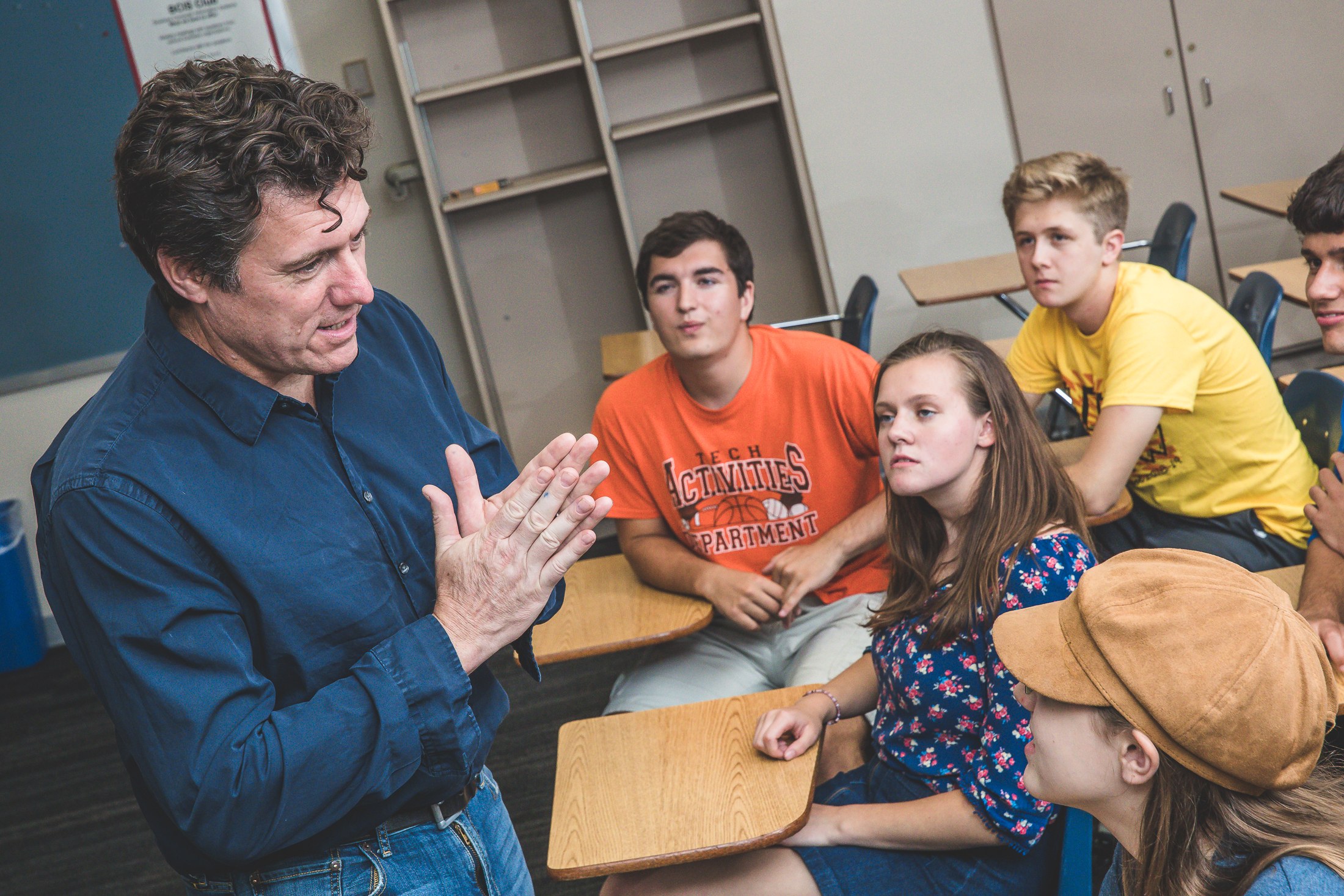 Aric Putnam talking with students in a classroom