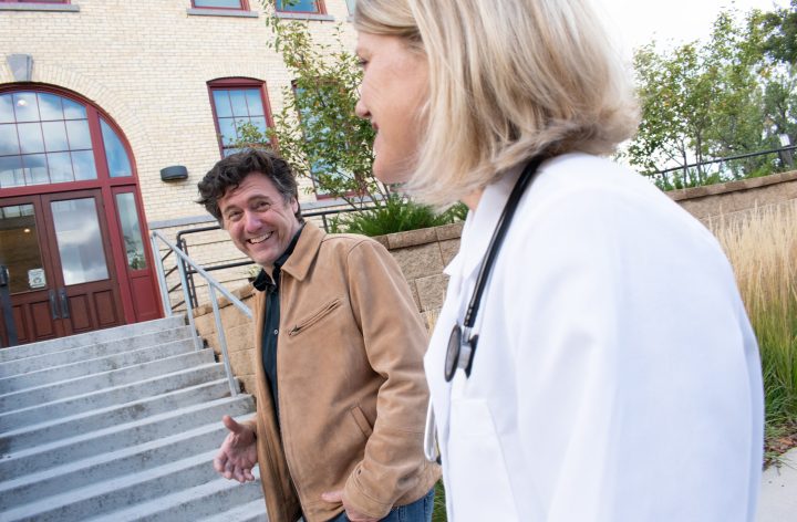 Aric Putnam talking with a physician outside a St. Cloud clinic