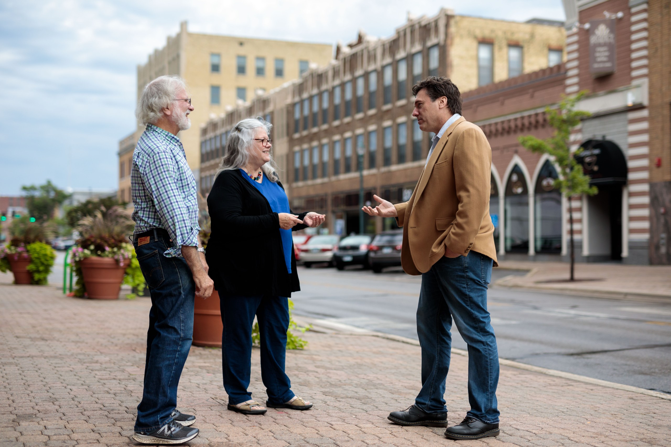 Aric Putnam talking with residents on a St. Cloud street corner